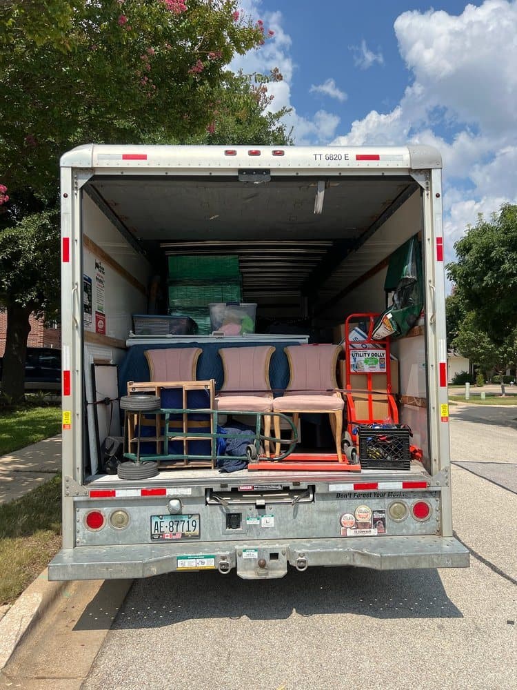 Chairs and furniture loaded into the back of a box truck