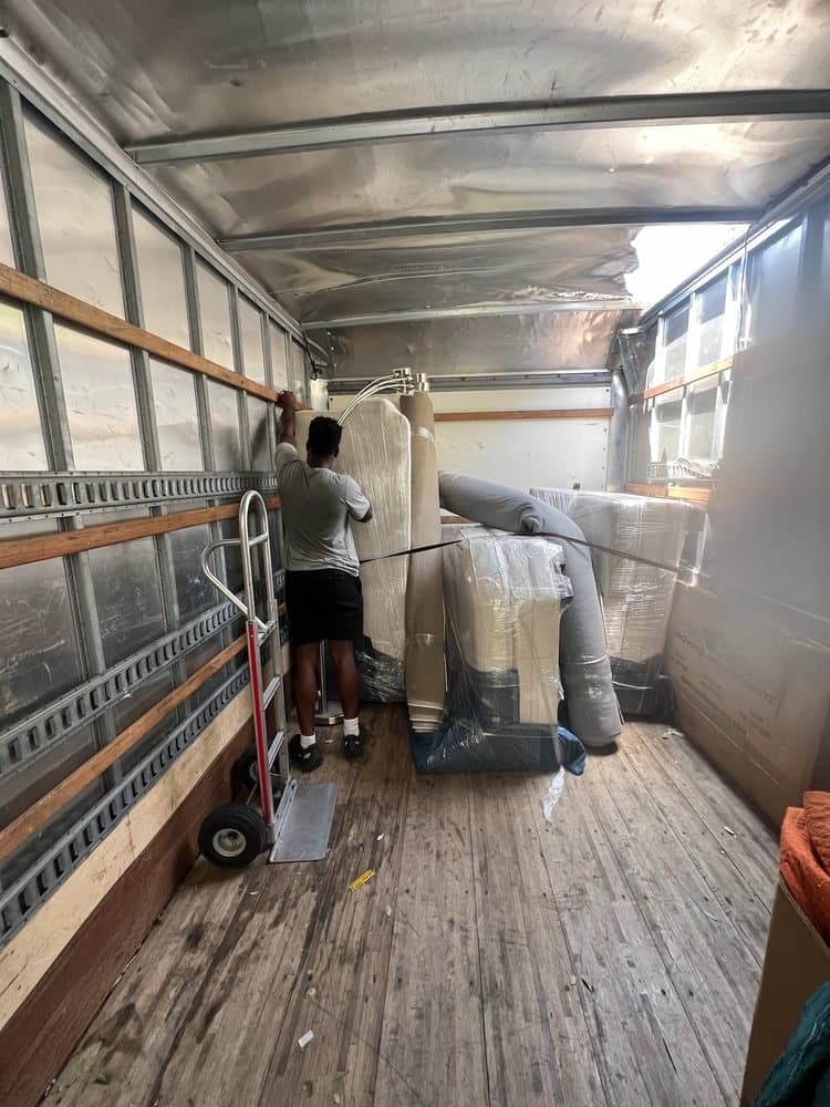 A Nu2U mover arranging a load inside a moving truck