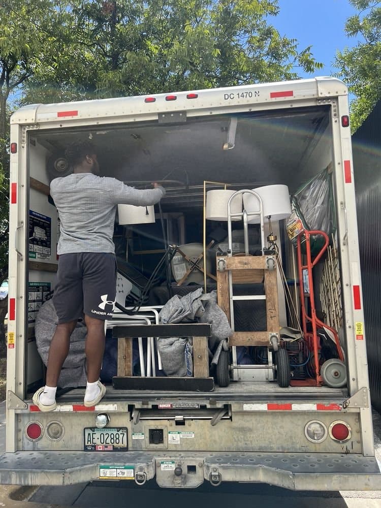 A Nu2U mover loading lamps and furniture into a box truck
